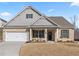 Charming single-Gathering home with brick and siding, a two-car garage, and a beautifully landscaped front yard at 7995 Brewton Creek Dr, Cumming, GA 30028