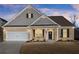 Well-maintained home featuring a brick facade, attached two-car garage, and inviting front porch area with tasteful decor at 7995 Brewton Creek Dr, Cumming, GA 30028
