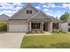 Charming single-Gathering home featuring a brick facade, well-manicured lawn, and inviting curb appeal under a sunny sky at 7995 Brewton Creek Dr, Cumming, GA 30028