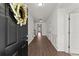 An inviting foyer with dark hardwood floors and white wainscoting, leading into the home's bright and open living spaces at 7995 Brewton Creek Dr, Cumming, GA 30028