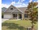 Beautifully landscaped front yard with a well-maintained lawn, and a brick and shingle home with an attached garage at 7995 Brewton Creek Dr, Cumming, GA 30028