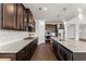 Spacious kitchen with granite countertops, stainless steel appliances, dark wood cabinets, and pendant lights at 7995 Brewton Creek Dr, Cumming, GA 30028