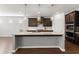 Kitchen island with granite countertops and pendant lighting, complemented by stainless steel appliances at 7995 Brewton Creek Dr, Cumming, GA 30028