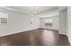 Open living room with large windows, recessed lighting, and sleek wood flooring provides a modern appeal at 7995 Brewton Creek Dr, Cumming, GA 30028