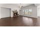 Bright and airy living room with hardwood floors, a cozy fireplace, and large windows, creating a warm and inviting atmosphere at 7995 Brewton Creek Dr, Cumming, GA 30028