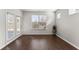 Bright living room with ample natural light, featuring wood floors and access to the outdoor space at 7995 Brewton Creek Dr, Cumming, GA 30028