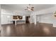 Expansive living area showcasing an open layout and seamlessly connected kitchen with dark wood floors at 7995 Brewton Creek Dr, Cumming, GA 30028