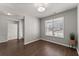 Cozy living room with hardwood floors, neutral walls, and a large window, offering an abundance of natural light at 7995 Brewton Creek Dr, Cumming, GA 30028