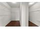 Walk-in closet includes built-in shelving with brown floors at 7995 Brewton Creek Dr, Cumming, GA 30028
