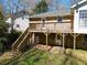 Exterior shot of a brick house featuring a wooden deck, stairs and a spacious backyard at 1131 Mayfield Dr, Decatur, GA 30033