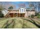Exterior shot of a brick house featuring a wooden deck, stairs and a spacious backyard at 1131 Mayfield Dr, Decatur, GA 30033
