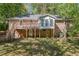 Exterior shot of a brick house featuring a wooden deck, stairs and a spacious backyard at 1131 Mayfield Dr, Decatur, GA 30033