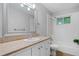 Bathroom features white fixtures, vanity with granite countertop, and shower-tub combo at 1131 Mayfield Dr, Decatur, GA 30033
