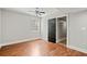 Bedroom with wood-look floors, ceiling fan, and a large closet space at 1131 Mayfield Dr, Decatur, GA 30033