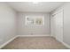 Bedroom features neutral walls, carpet flooring, closet, and natural light from the window at 1131 Mayfield Dr, Decatur, GA 30033