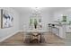 Elegant dining room with stylish lighting, a modern table, and views into the kitchen at 1131 Mayfield Dr, Decatur, GA 30033