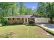 Charming one-story brick home with a well-manicured lawn and mature trees, creating a welcoming curb appeal at 1131 Mayfield Dr, Decatur, GA 30033