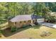 Aerial view of a charming ranch-style home with brick facade, attached garage, and mature trees at 1131 Mayfield Dr, Decatur, GA 30033