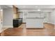 Kitchen in finished basement with stainless hood, cooktop, bar island and neutral backsplash at 1131 Mayfield Dr, Decatur, GA 30033