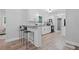 Bright kitchen featuring white cabinets, stainless steel appliances, granite countertops, and a breakfast bar at 1131 Mayfield Dr, Decatur, GA 30033