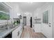 Bright kitchen features white cabinets, granite counters, stainless sink, and modern appliances at 1131 Mayfield Dr, Decatur, GA 30033