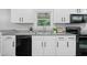 Kitchen features white cabinets, granite countertops and black appliances at 1131 Mayfield Dr, Decatur, GA 30033