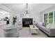Bright and airy living room with a fireplace, modern decor, and large windows offering natural light at 1131 Mayfield Dr, Decatur, GA 30033