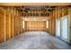 Unfinished room featuring bare studs, windows and door; ready for customization at 1131 Mayfield Dr, Decatur, GA 30033