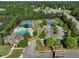Aerial view of the community pool, tennis courts, and landscaped entrance of a beautiful residential neighborhood at 1963 Skybrooke Ln, Hoschton, GA 30548