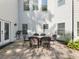 Outdoor dining area with a patio, table, chairs, and well maintained landscaping at 1963 Skybrooke Ln, Hoschton, GA 30548