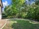 Large backyard featuring a well-maintained lawn, privacy trees, and access to the pool at 1963 Skybrooke Ln, Hoschton, GA 30548