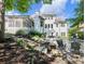 Expansive backyard with a pool, stone patio, and outdoor dining area perfect for entertaining guests at 1963 Skybrooke Ln, Hoschton, GA 30548