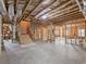 Unfinished basement with exposed beams, staircase, and ample space for customization and future expansion at 1963 Skybrooke Ln, Hoschton, GA 30548