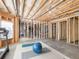 Open basement with partially finished area ideal for custom design, including exercise equipment and workout space at 1963 Skybrooke Ln, Hoschton, GA 30548