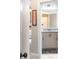 A view of a bathroom vanity with granite countertop as seen from a bedroom through an open doorway at 1963 Skybrooke Ln, Hoschton, GA 30548