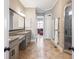 Elegant bathroom with dual sinks, granite countertops, tiled floors, and a walk-in shower for a luxurious feel at 1963 Skybrooke Ln, Hoschton, GA 30548