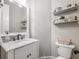 Stylish half bathroom featuring marble countertop, floating shelves, and modern fixtures at 1963 Skybrooke Ln, Hoschton, GA 30548