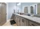 Modern bathroom features granite countertops, double sinks, and a neutral color scheme at 1963 Skybrooke Ln, Hoschton, GA 30548