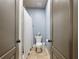 Charming bathroom featuring a toilet, shower with a black and white curtain, and neutral wall paint at 1963 Skybrooke Ln, Hoschton, GA 30548