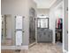 Modern bathroom with glass-enclosed shower, dual vanities, tile flooring, and a walk-in closet for ample storage at 1963 Skybrooke Ln, Hoschton, GA 30548
