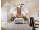 Vaulted bedroom with a ceiling fan, bed between bedside tables, and decor on the walls at 1963 Skybrooke Ln, Hoschton, GA 30548