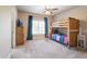 Bright bedroom with a wooden bunk bed, a large window with dark curtains, and neutral carpeting at 1963 Skybrooke Ln, Hoschton, GA 30548