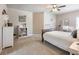 Bedroom with a large bed, a desk area with decor, and a view of a serene space at 1963 Skybrooke Ln, Hoschton, GA 30548
