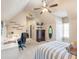 Spacious bedroom with decor, ceiling fan, and desk area with natural light from the window at 1963 Skybrooke Ln, Hoschton, GA 30548