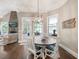 Eat-in dining area featuring hardwood floors, large windows, and access to an outdoor patio at 1963 Skybrooke Ln, Hoschton, GA 30548