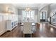 Dining area with wainscoting, a large window, and views of the front entrance at 1963 Skybrooke Ln, Hoschton, GA 30548
