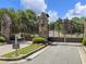Wrought iron security gate with stone pillars and lush landscaping at 1963 Skybrooke Ln, Hoschton, GA 30548