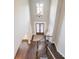 A top-down view of a stunning entryway showcases dark wood floors and double doors at 1963 Skybrooke Ln, Hoschton, GA 30548