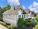 Charming home exterior features a well-manicured lawn and mature landscaping at 1963 Skybrooke Ln, Hoschton, GA 30548