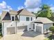 Spacious home with a three-car garage, complemented by a large driveway and manicured lawn at 1963 Skybrooke Ln, Hoschton, GA 30548